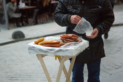 Midsection of man preparing food