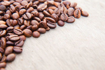 Roasted coffee beans on wooden table