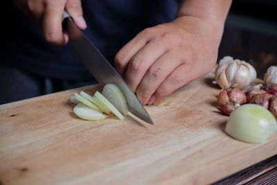 Close-up of person preparing food on cutting board