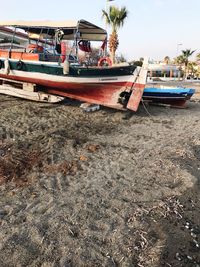 Boat moored on beach against clear sky