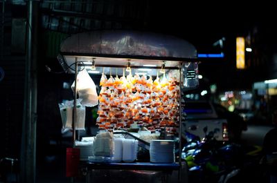 Close-up of various food on display at night