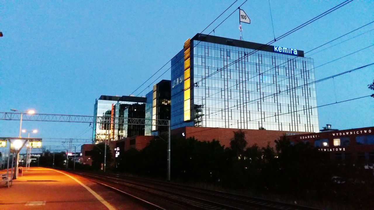 CARS ON ROAD AGAINST SKY IN CITY