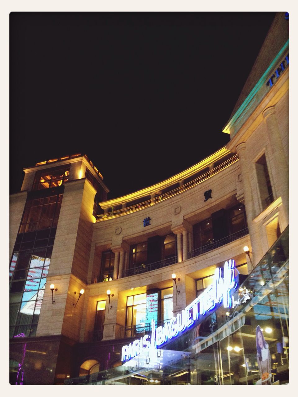 architecture, building exterior, built structure, illuminated, low angle view, night, clear sky, city, building, transfer print, city life, auto post production filter, lighting equipment, street light, outdoors, blue, residential building, sky, copy space, no people