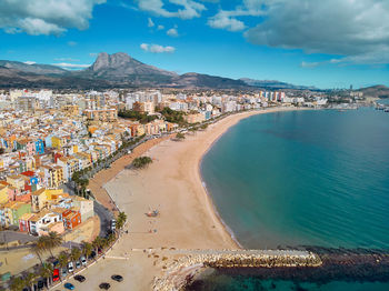 High angle view of sea and buildings against sky