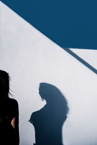 Shadow of woman on white wall
