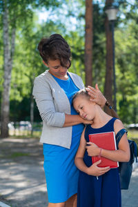 Mother and daughter embracing outdoors