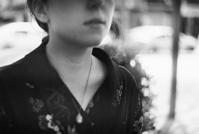 Close-up portrait of young woman looking away