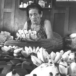 Close-up of woman sitting on table