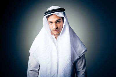 Portrait of mid adult man against gray background