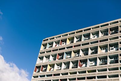 Low angle view of apartment building against blue sky