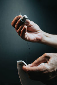 Cropped hands of woman sewing textile