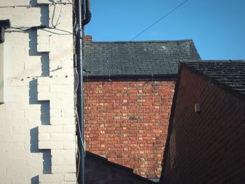 Low angle view of brick wall against sky