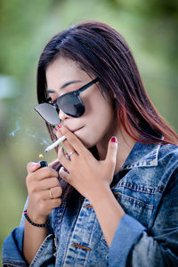 Portrait of young woman using mobile phone