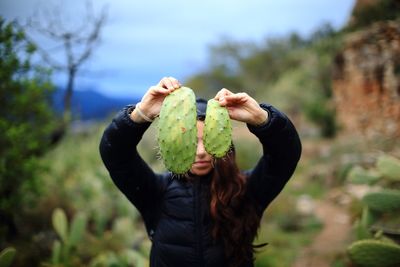 Close-up of woman holding leaf