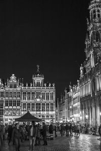 Group of people in front of building at night