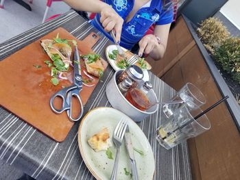 High angle view of man preparing food on table