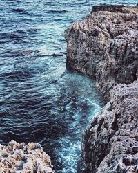 High angle view of rock formations by sea