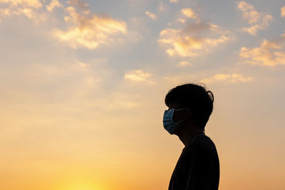 Portrait of silhouette man standing against sky during sunset