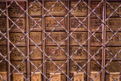 Full frame shot of metal fence against wall