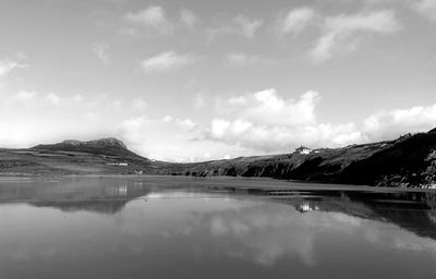 Scenic view of lake and mountains against sky