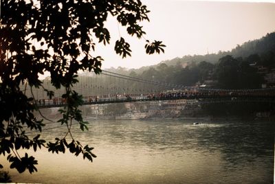 Scenic view of river by trees against sky