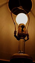 Low angle view of illuminated lamp against sky