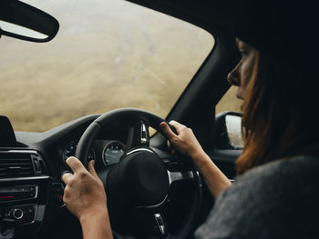 Woman driving car through glen etive