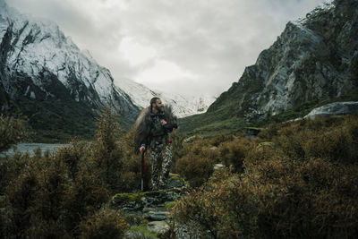 Hunter in mountains looking away