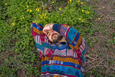 Moroccan man laying on the ground with his hand over his face