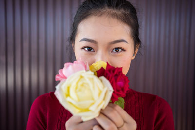 Close-up portrait of woman holding ice cream