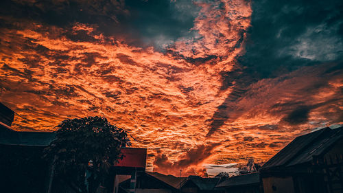 Low angle view of silhouette buildings against sky during sunset