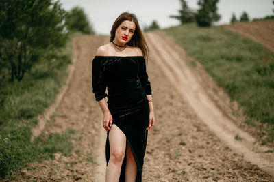 Portrait of woman standing on field