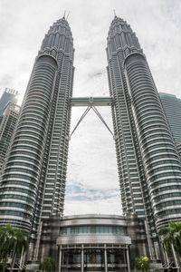 Low angle view of buildings against cloudy sky