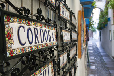 Low angle view of text on street amidst buildings