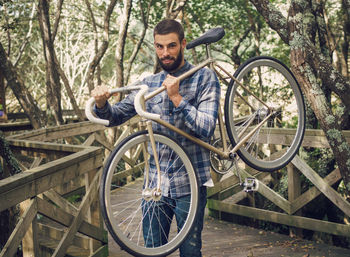 Portrait of young man sitting on bicycle