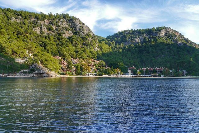 water, tree, mountain, tranquil scene, scenics, waterfront, tranquility, sky, beauty in nature, lake, nature, cloud - sky, idyllic, mountain range, cloud, river, rippled, non-urban scene, forest, day