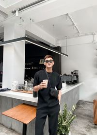 Full length of man standing by glass