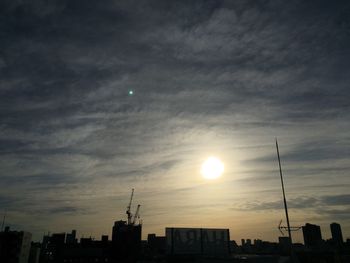 Low angle view of buildings against cloudy sky during sunset