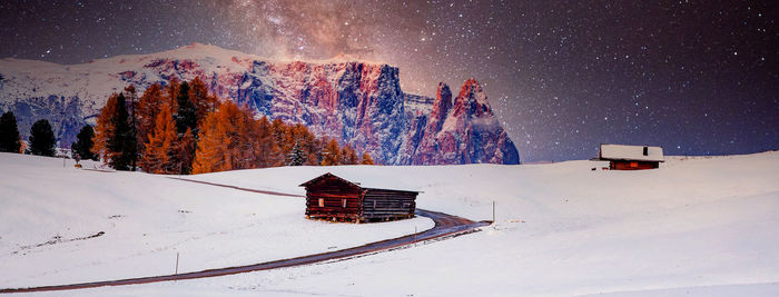 Snow covered land and mountains against sky