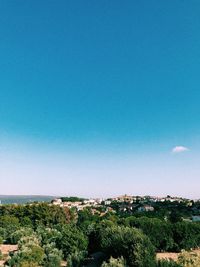 Scenic view of townscape against clear blue sky