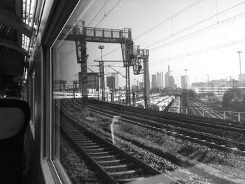 Train on railway tracks in city against sky