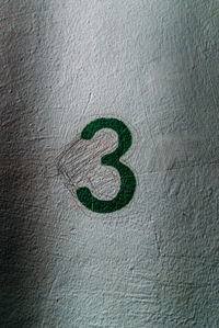 Close-up of number 3 on wall