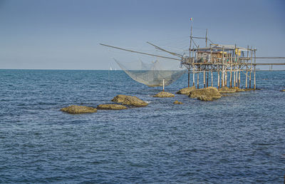 Sailboat on sea against clear sky