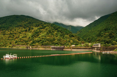 Scenic view of lake and mountains against sky