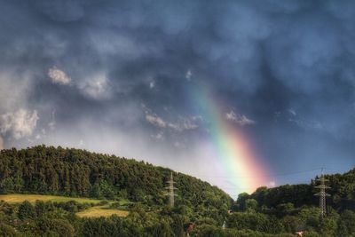 Rainbow over landscape against sky