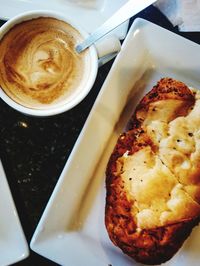 Close-up of cappuccino served on table