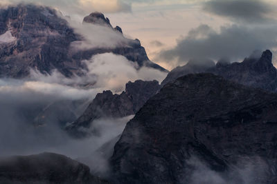 Scenic view of mountains against cloudy sky