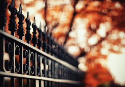 Low angle view of metal railing against defocused background