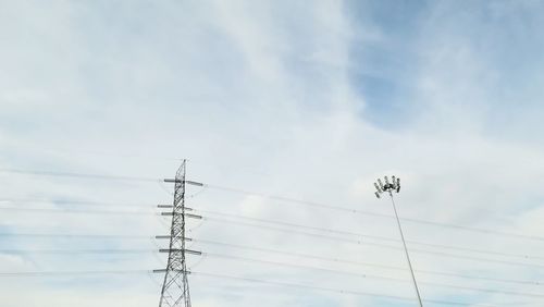Low angle view of electricity pylon against sky