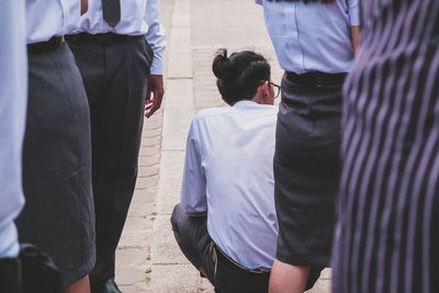 Rear view of people sitting on street